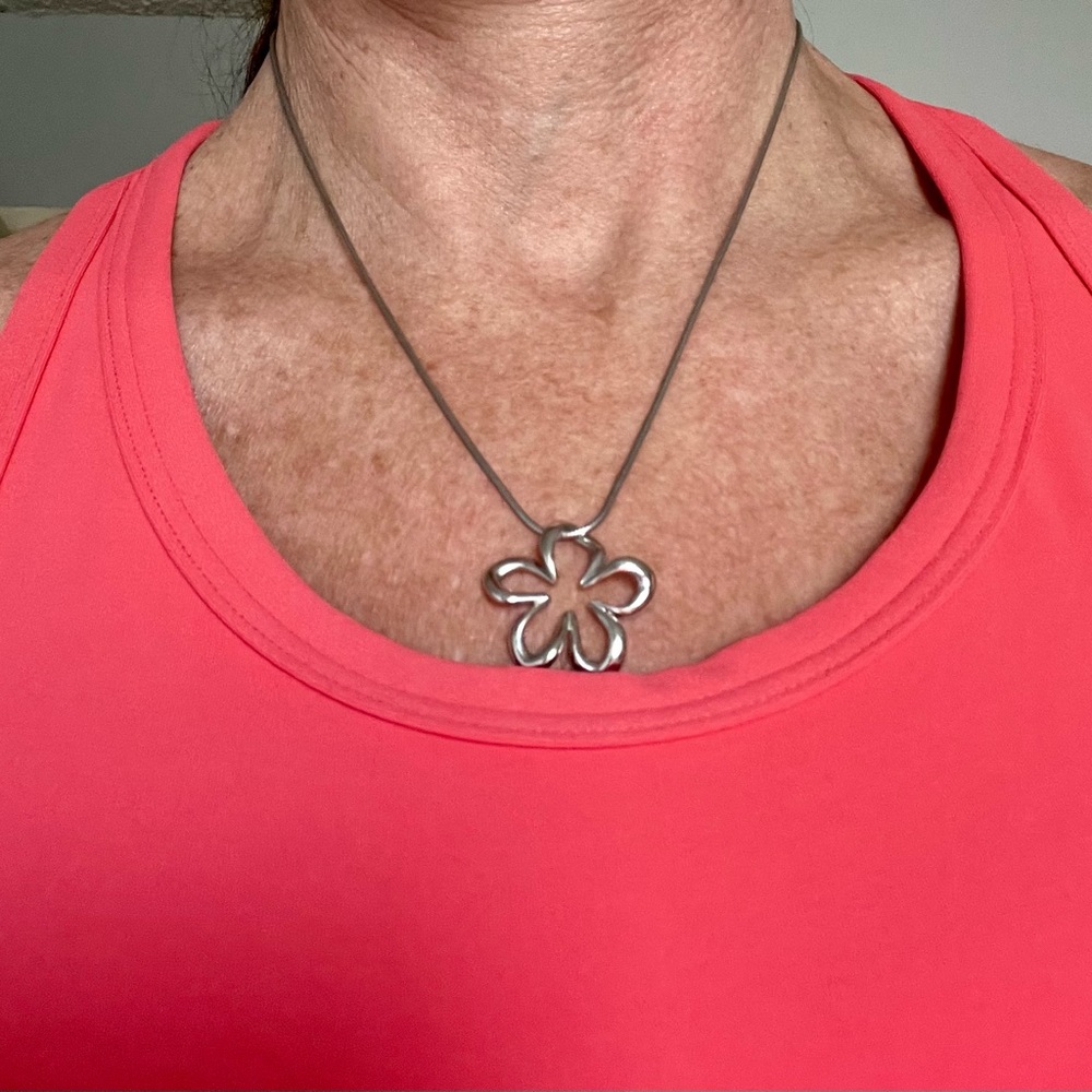 Flower 3/4 inch sterling silver pendant on 18 in sterling silver chain.